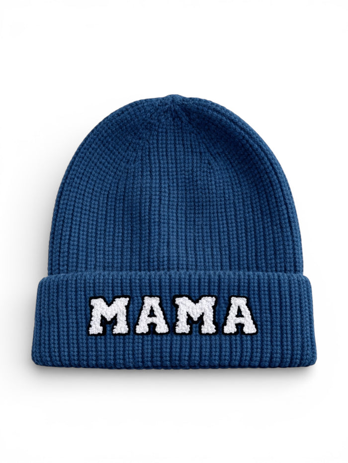 Blue knitted beanie with a folded cuff featuring the word "MAMA" in white letters.