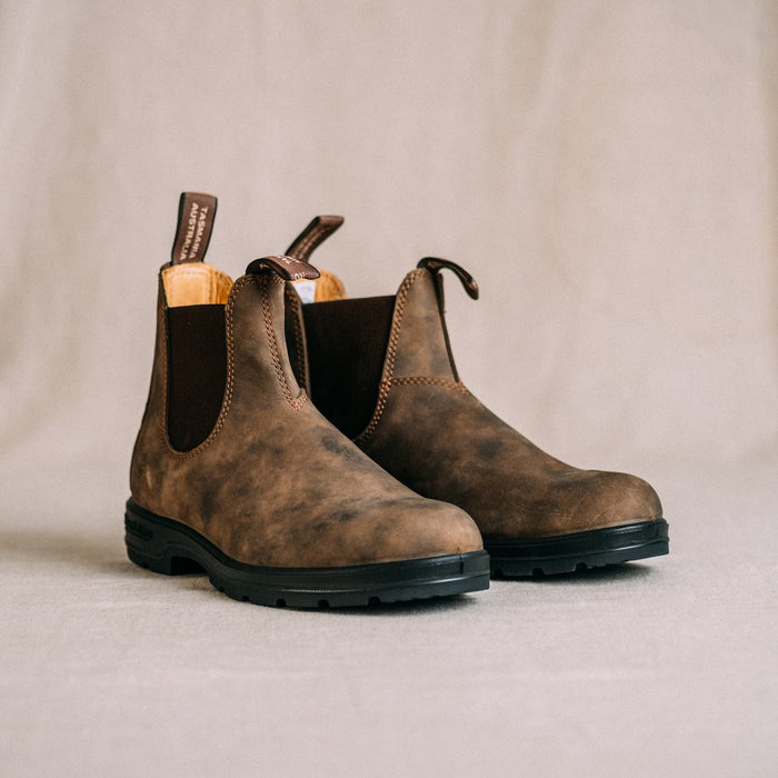 Pair of brown leather boots on a beige background