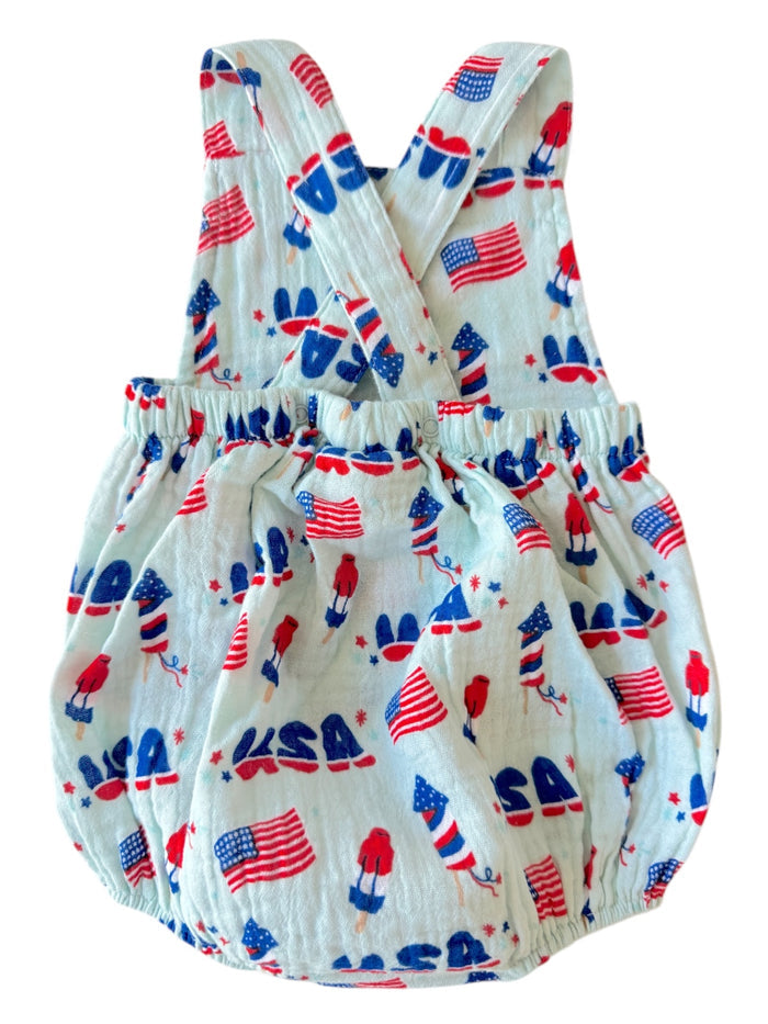Children's romper with red, white, and blue patriotic print featuring USA flags and gnomes.