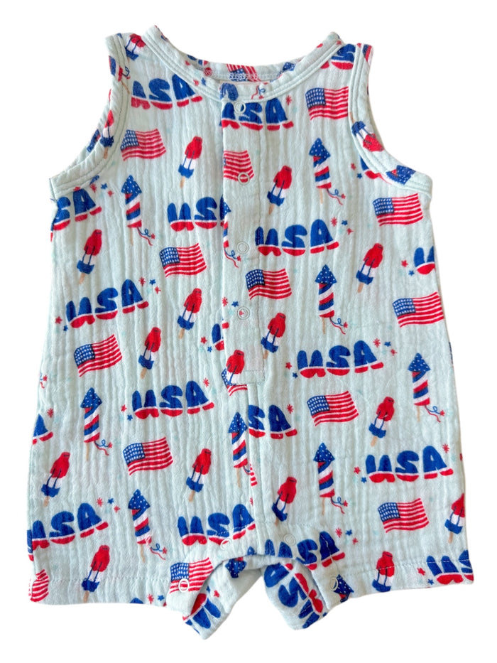 Children's romper with a festive print featuring USA flags and rockets in red, white, and blue colors.