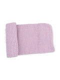 Light pink and white gingham fabric folded neatly. Ideal for crafting or home decor projects.
