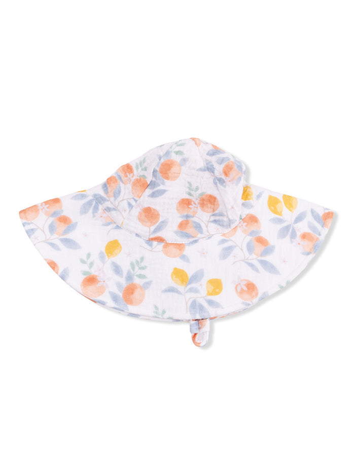 White hat with a floral pattern in orange, yellow, and green leaves.