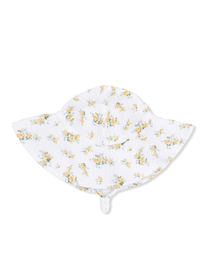Floral white sun hat with yellow flowers, wide brim, and chin strap. Perfect for sunny days outdoors.