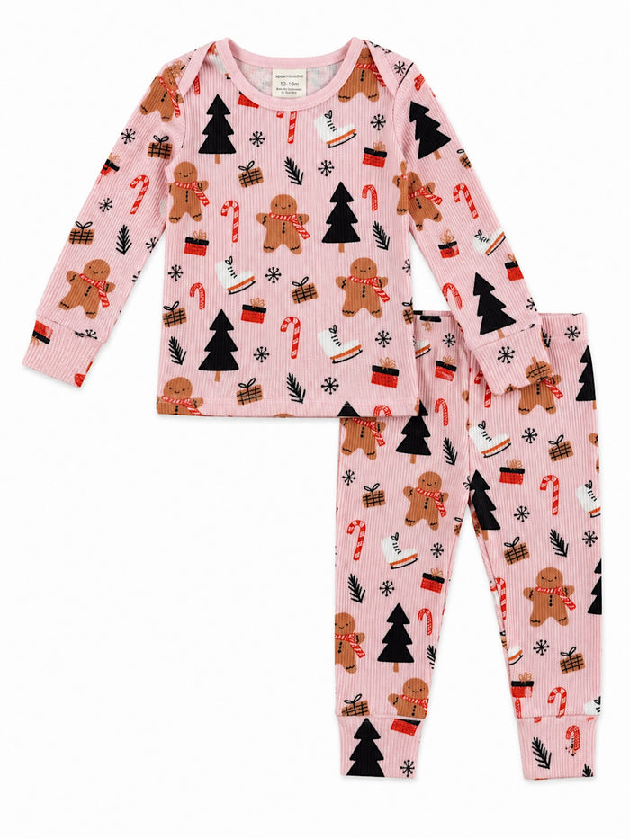 Pink pajama set featuring gingerbread men, candy canes, trees, and presents, perfect for cozy winter nights.