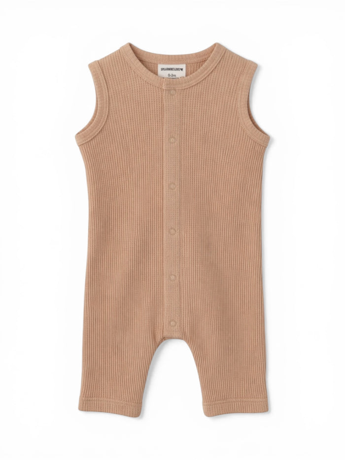 Tan ribbed baby romper with shoulder snaps and short legs, ideal for warm-weather outfits.