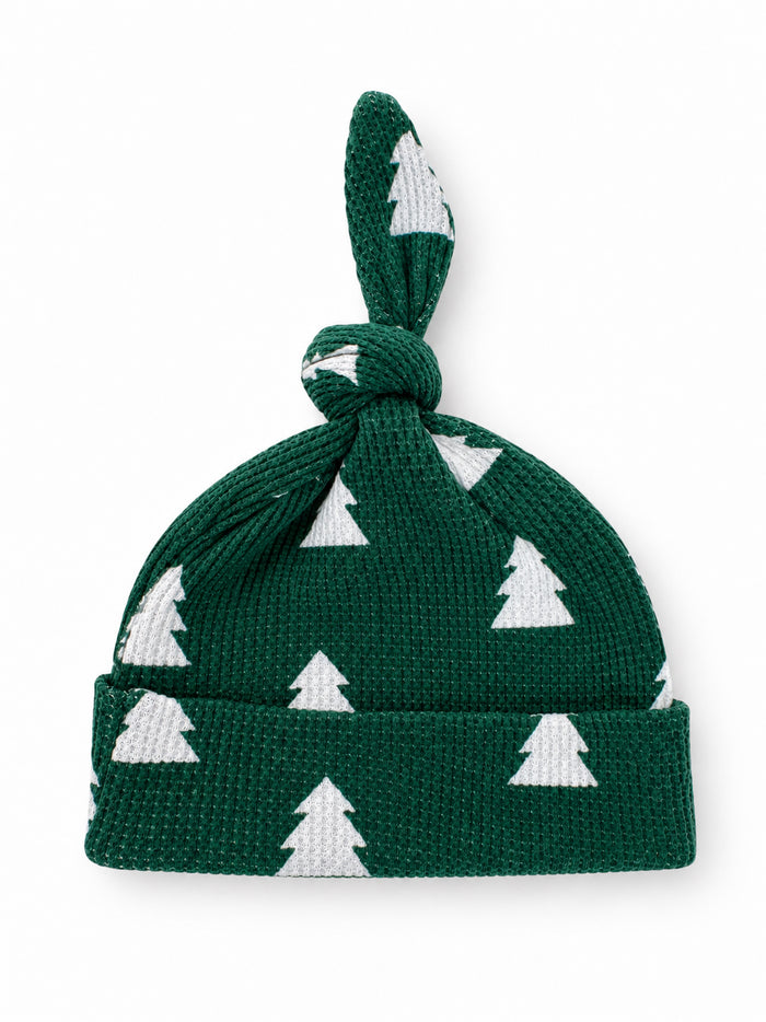 Green knit baby hat with white Christmas tree pattern and knot on top.
