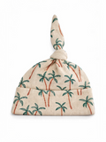Palm-patterned beanie hat with a knotted top, designed for a casual, tropical style.