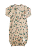 Baby sleep sack featuring a palm tree print on a light background, soft fabric, and snap closure design.