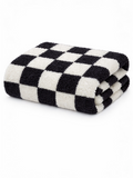 Black and white checkered towel folded neatly on a white background.
