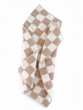 Brown and white checkered towel draped elegantly on a white background.