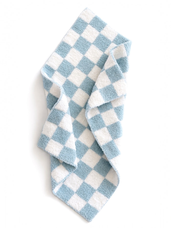 Blue and white checkered towel draped, showcasing its soft texture and pattern.