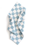 Blue and white checkered towel draped, showcasing its soft texture and pattern.