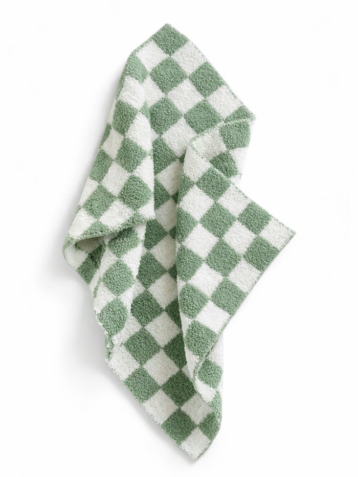 Green and white checkered towel draped, featuring a soft, textured fabric. Ideal for kitchen or bathroom use.