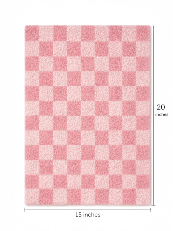 Pink checkered rug measuring 15 by 20 inches, featuring a plush texture and soft surface.