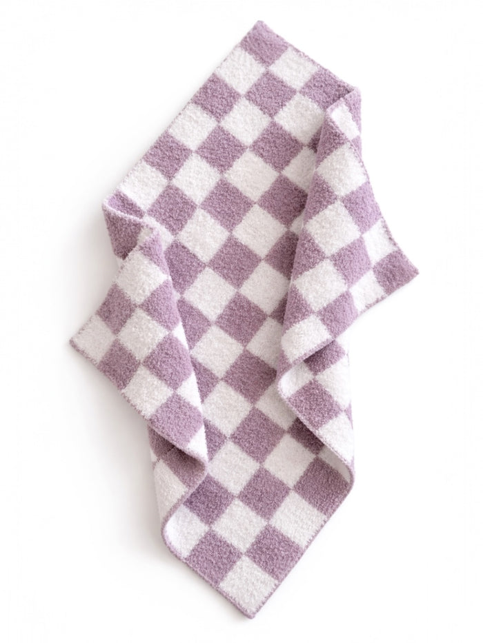 Purple and white checkered fabric draped on a flat surface, showcasing its soft texture and pattern.