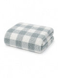 Soft, folded blanket with a blue and white checkered pattern on a white background.