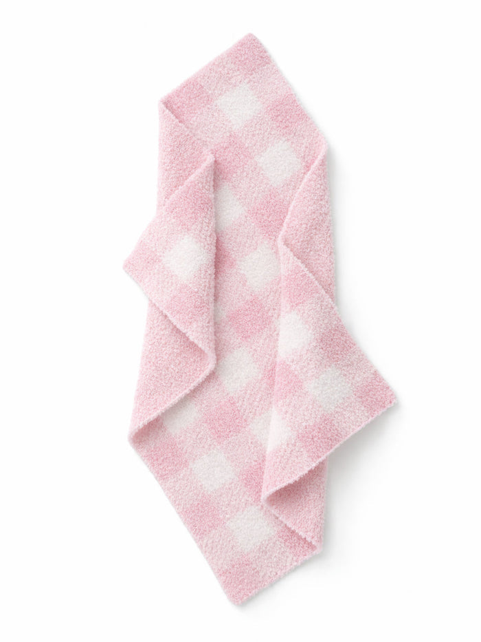 Pink checkered towel folded on a white background, featuring a soft, plush texture.