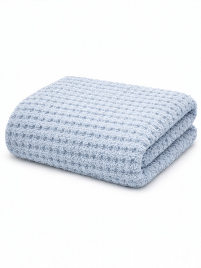 Light blue textured blanket folded neatly on a white background. Ideal for warmth and comfort.