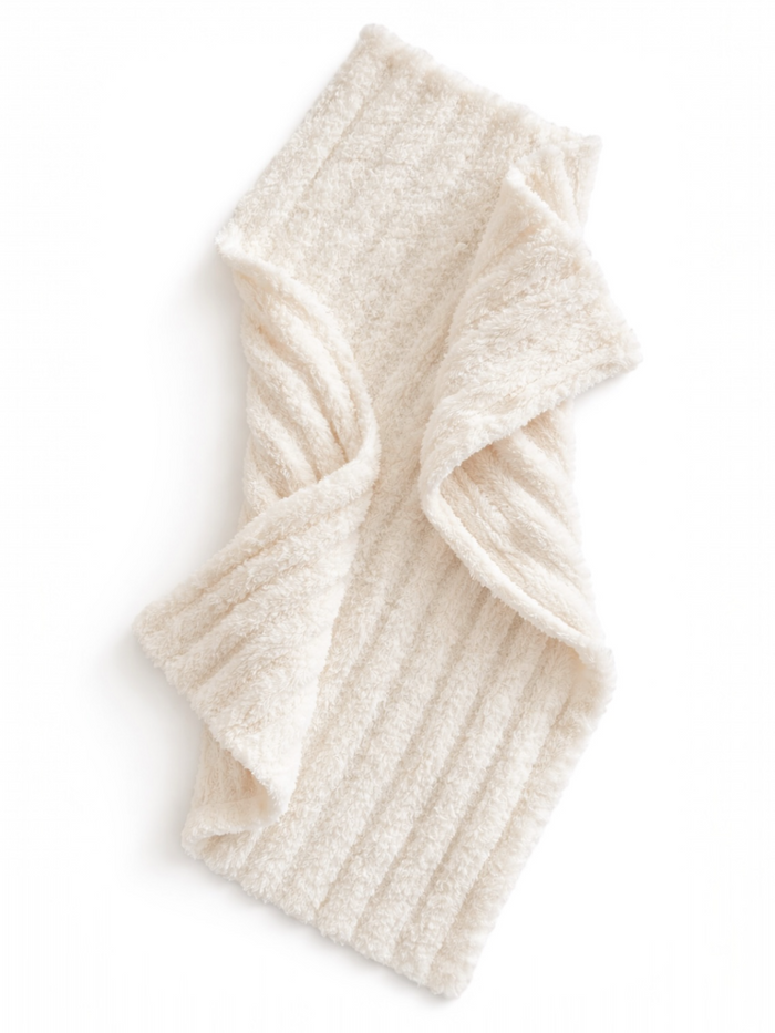 Soft cream-colored fleece scarf with a ribbed texture, elegantly draped.