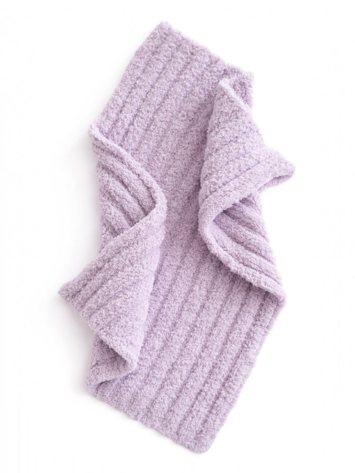 Lavender, textured scarf draped artistically, showcasing its soft and cozy fabric.