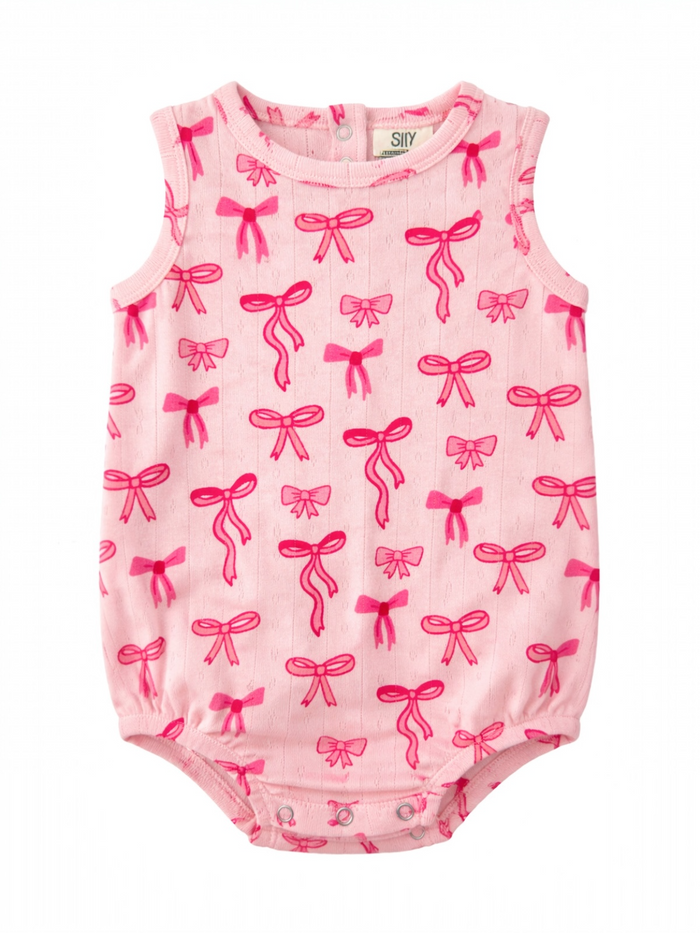 Pink infant bodysuit with a pattern of bright pink bows on a light background.