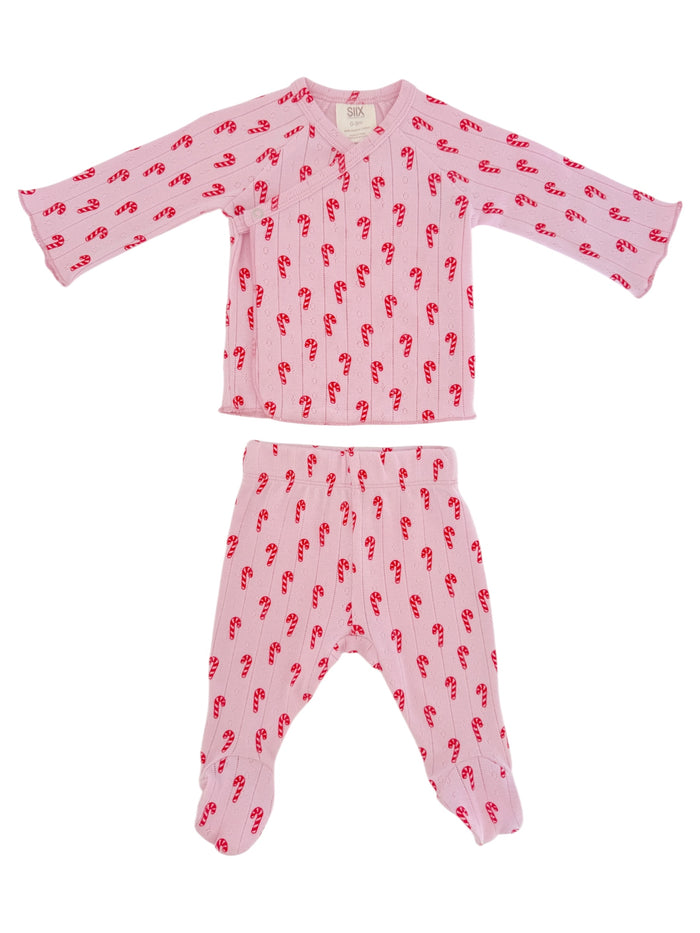 Pink pajama set with candy cane pattern; includes long-sleeved top and matching footed pants.