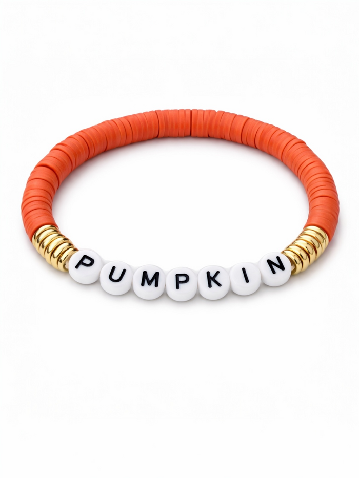 Orange beaded bracelet with white letter beads spelling "PUMPKIN" and gold accents.