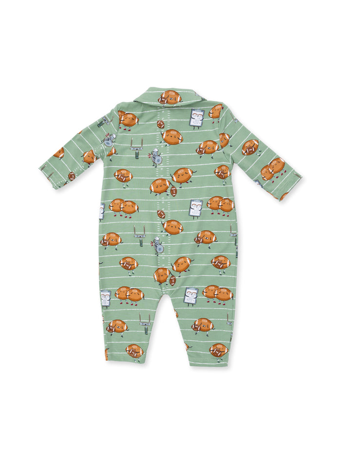 Green pajamas patterned with playful cartoon footballs and characters, featuring a collar and long sleeves.