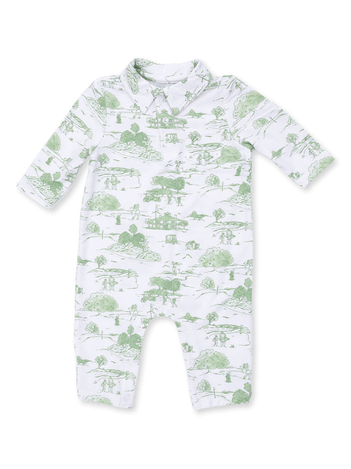 White baby romper with green nature-themed print featuring trees, houses, and people in a pastoral scene.