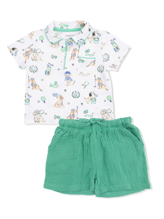 Children's outfit featuring a playful dog-themed polo shirt and soft green shorts. Ideal for casual wear.