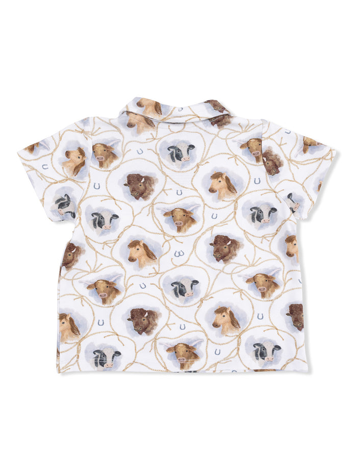 White shirt featuring a playful print of farm animal faces and horseshoes. Ideal for casual wear.