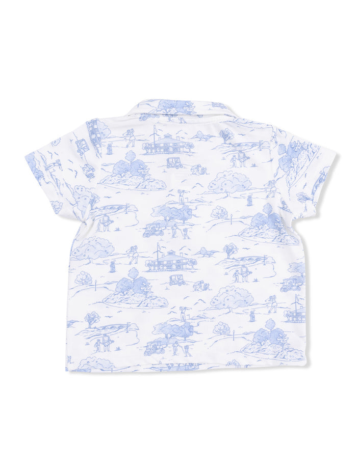 Back view of a short-sleeve white shirt featuring a blue landscape print with people and nature scenes.