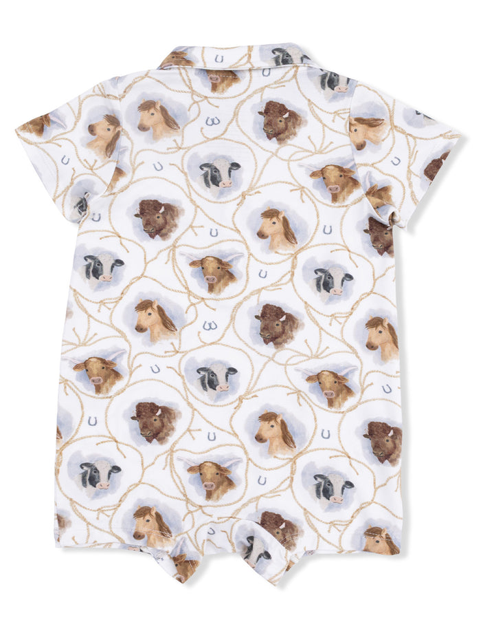 Children's romper featuring a playful pattern of animal heads including cows and horses on a light background.