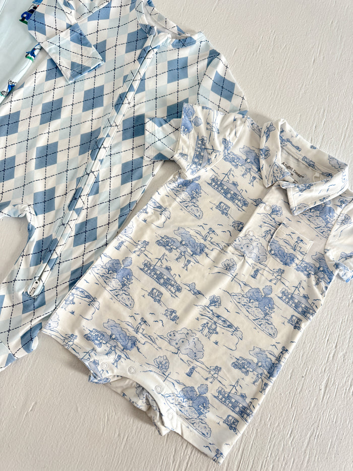 Two infant rompers in light blue patterns: one with an argyle design and the other featuring whimsical scenes.