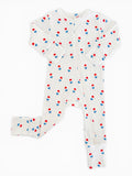 White baby onesie with red and blue popsicle pattern, featuring long sleeves and a zipper closure.