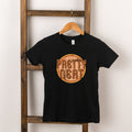 Black t-shirt hanging on a wooden ladder, featuring "Pretty Neat" graphic design in vibrant colors.