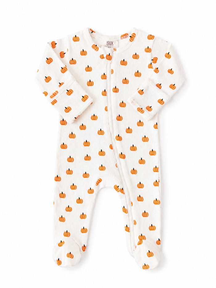 White baby onesie with orange pumpkin prints, featuring a zipper and long sleeves. Perfect for autumn or Halloween.