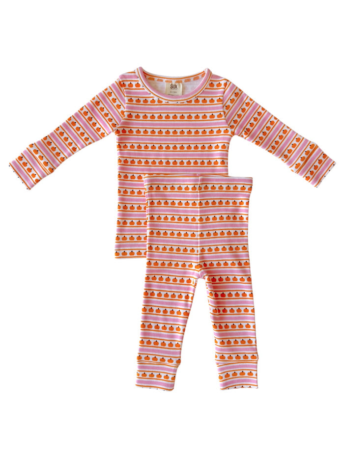 Children's pajama set featuring long-sleeve top and leggings with a pumpkin pattern on a pink striped background.