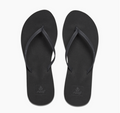 A pair of black Reef Bliss Nights flip flops with PVC free vegan leather straps and a soft foam footbed.