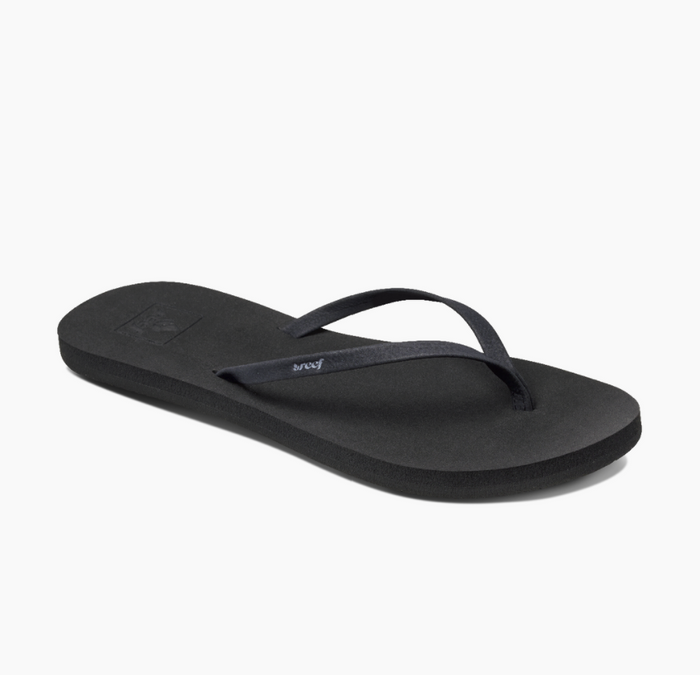 A pair of black Reef Bliss Nights flip flops with PVC free vegan leather straps and a soft foam footbed.