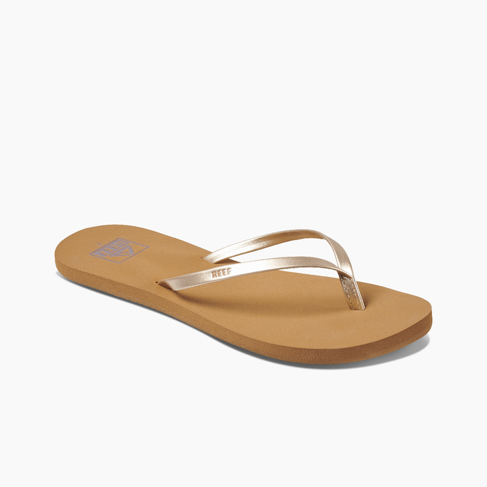 A pair of black Reef Bliss Nights flip flops with PVC free vegan leather straps and a soft foam footbed.