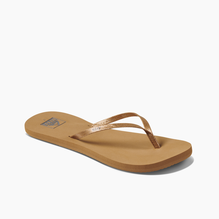 A pair of black Reef Bliss Nights flip flops with PVC free vegan leather straps and a soft foam footbed.
