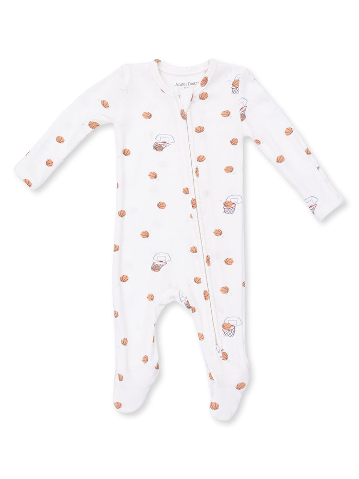 White baby onesie with basketball and hoop pattern, featuring a front zipper and long sleeves.