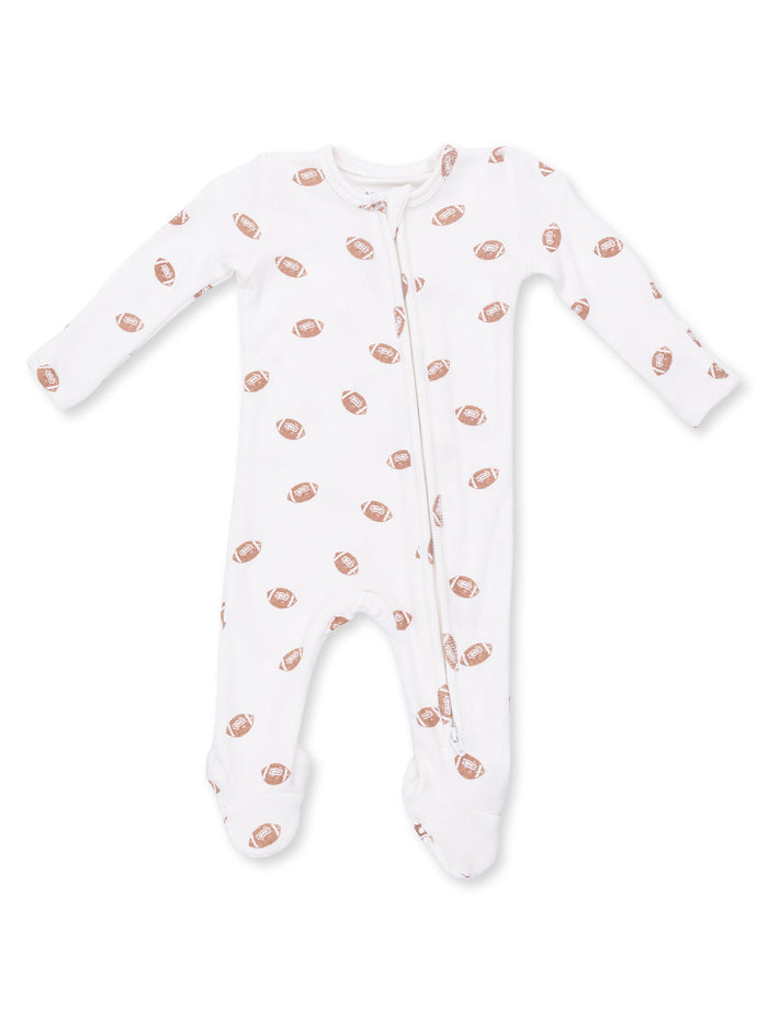 White infant onesie with football prints, featuring a front zipper and long sleeves.