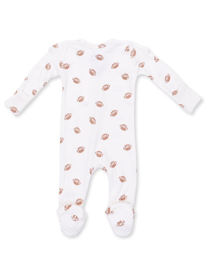 White baby onesie with repeating brown football pattern and non-slip feet for added safety. Perfect for infants.