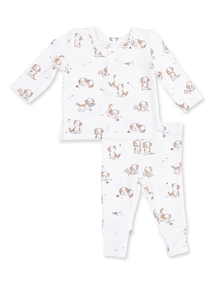 White baby pajama set featuring playful puppy prints on a long-sleeve top and pants.