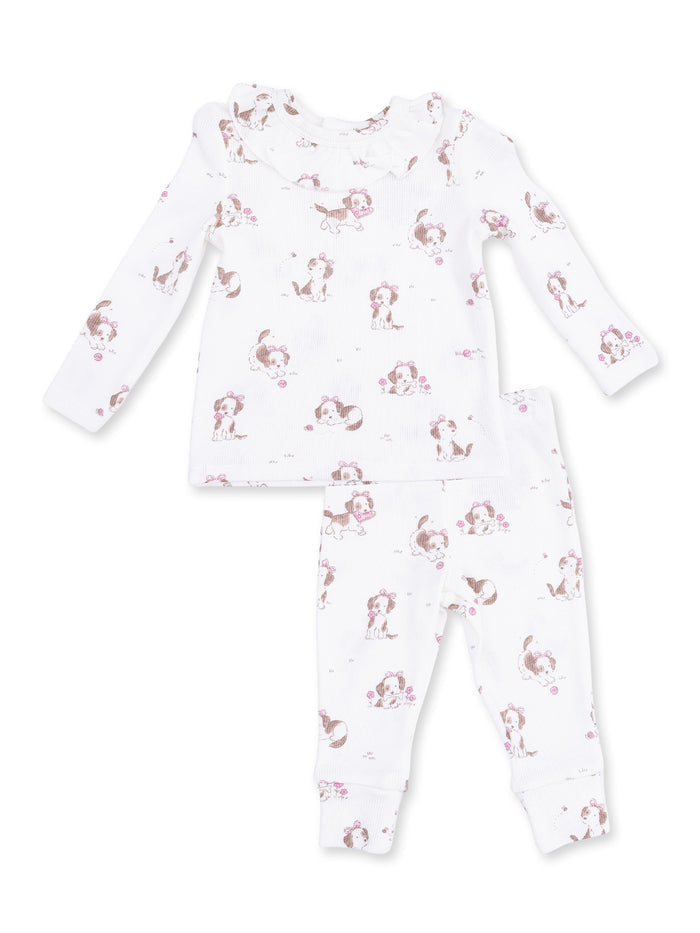 White baby pajamas featuring playful puppy patterns, including a long-sleeve top and matching pants.