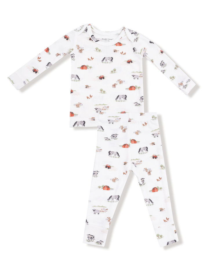 Kids' two-piece pajama set with farm animal patterns on a white background. Ideal for comfort and play.