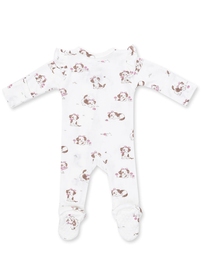 White baby onesie with playful puppy prints and floral accents, featuring long sleeves and footed design.