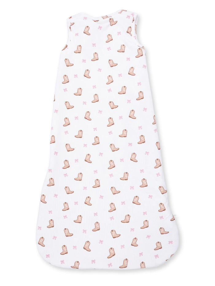 White sleeveless sleep sack with pink cowboy boot and bow patterns. Ideal for cozy sleepwear.